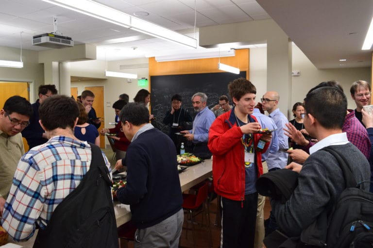 people having snacks and discussing at the Workshop on Probabilistic and Extremal Combinatorics