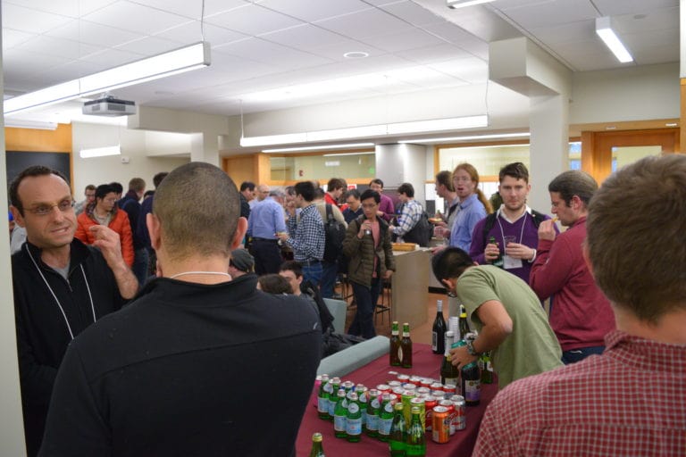 people enjoying the drink while one boy is looking at the drinks closely