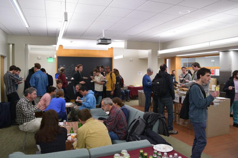 people having a discussion while eating at the Workshop on Probabilistic and Extremal Combinatorics